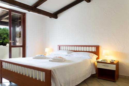 a bedroom with a bed with two towels on it at Belvedere in San Teodoro
