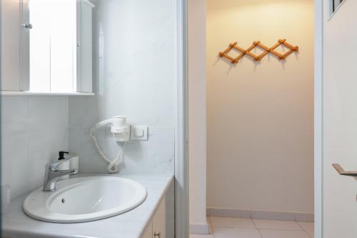 a bathroom with a sink and a shower at Port House in Kos