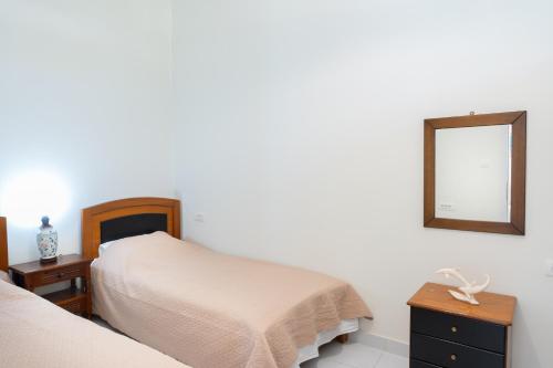 a bedroom with two beds and a mirror on the wall at Port House in Kos