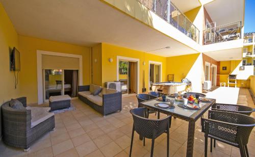 a living room with a table and chairs at C15 - The Patio do Convento Apartment in Lagos