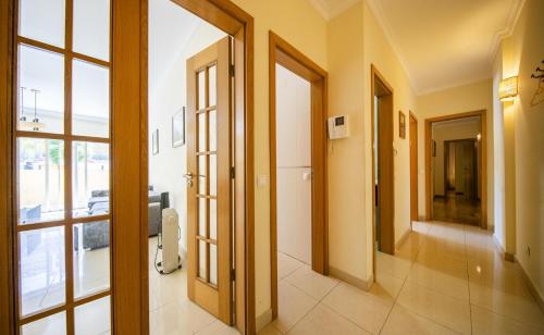 a hallway of a building with doors and windows at C15 - The Patio do Convento Apartment in Lagos