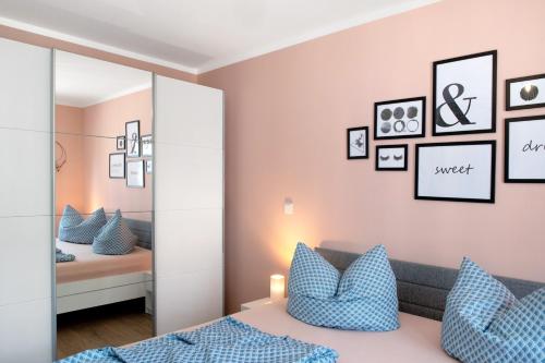 a bedroom with a mirror and a bed with blue pillows at Müritzblick in Vipperow