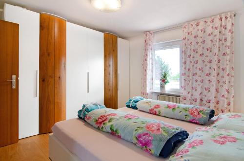 a bedroom with two beds and a window at Aida in Überlingen