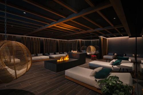 a rendering of a living room with couches and chairs at Anatura Hotel Luxembourg in Weiswampach