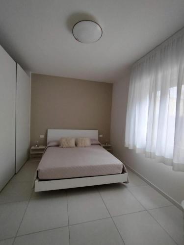 a bedroom with a bed and a large window at Apartment Mare Caorle int 1 in Caorle