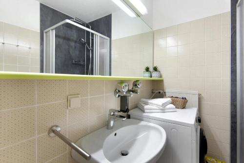 a bathroom with a sink and a mirror at Fewo S22 in Regen