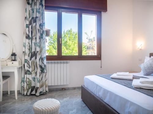 a bedroom with a bed and a desk and a window at Casa Bella Venezia 2 in Mestre