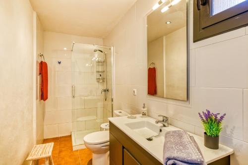 a white bathroom with a sink and a toilet at Castell del Montgrí Rural in Torroella de Montgrí