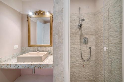 a bathroom with a sink and a shower with a mirror at Villa Nespolo in Levanto