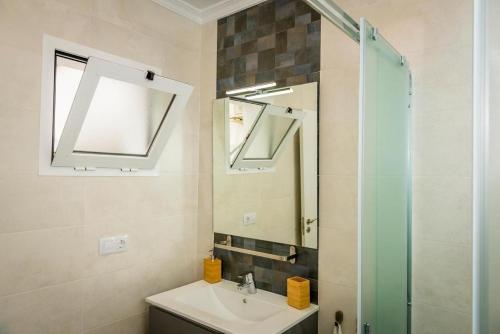 a bathroom with a sink and a mirror at Apartment Dolmen de Viera in Antequera