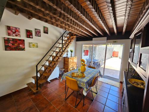 a dining room with a table and a staircase at Paradise House Furnas in Furnas