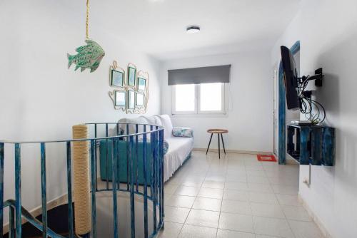 a living room with a couch and a tv at Las Sales Duplex in Moya