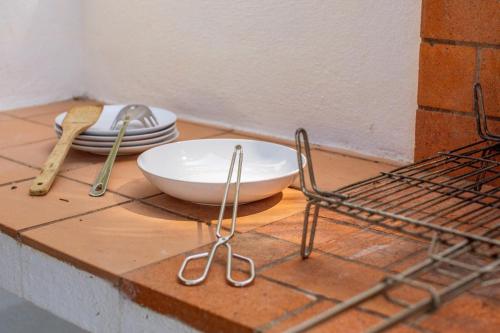 a table with a plate and utensils on a counter at Son Xoriguer 6 in Son Xoriguer