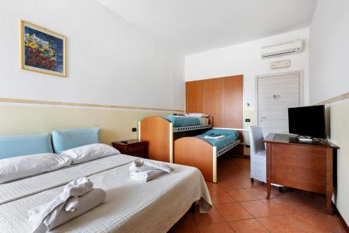 a hotel room with two beds and a television at B and B 7 Camini in Verona