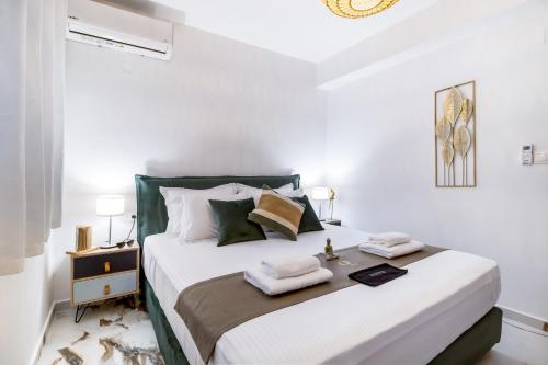 a bedroom with a bed with towels on it at Oceanida Afrodite Lyxury Suite in Nikiana