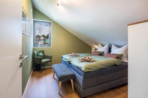 a bedroom with a bed and a chair in it at Gold Haus in Weilheim