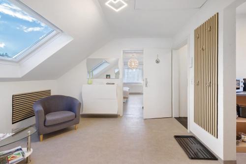 a living room with a window and a chair at Ferienwohnung Rosengarten in Mössingen