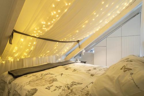 a bedroom with a bed with lights on the ceiling at Straub in Meckenbeuren