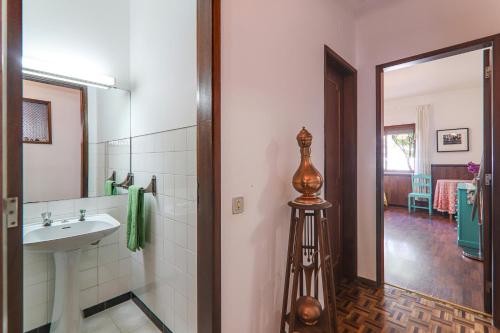 a bathroom with a sink and a mirror at Casa Tangerina in Tavira