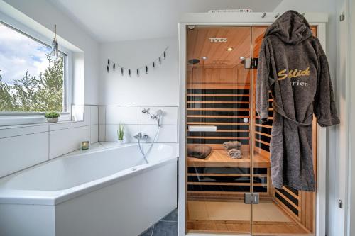a bathroom with a shower and a tub and a sink at An der Ostsee by Seeblick Ferien in Kappeln