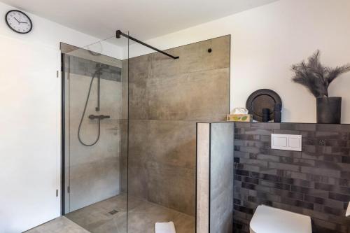 a shower with a glass door in a bathroom at Ferienwohnung-Bachlauf-Eslohe in Eslohe