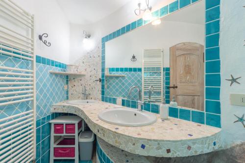 a bathroom with a sink and a mirror at Villa Rosa in Porto Rotondo