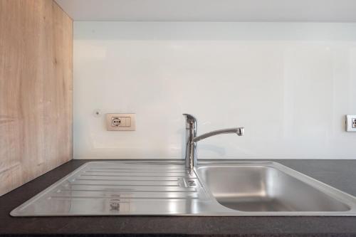 a kitchen sink with a faucet on a counter at Kohlerhof Apartment in San Genesio Atesino