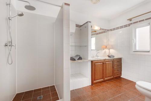 a bathroom with a shower and a toilet and a sink at Beach House Christine in Costa Calma