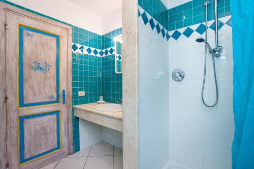 a bathroom with a sink and a shower at Pavoncella in Orosei