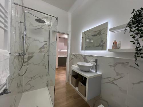 a white bathroom with a shower and a sink at Comfort Zone in Mestre