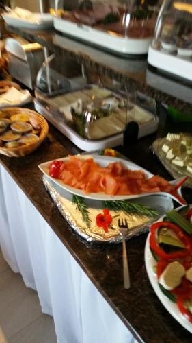 a buffet line with a bunch of food on a counter at Hotel Ackermann in Riedstadt
