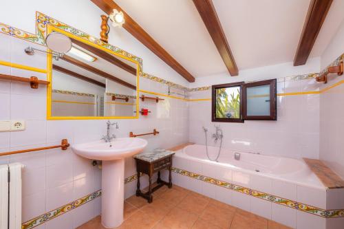 a bathroom with a sink and a bath tub and a sink at Ses Rodes in Felanitx