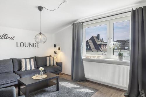 a living room with a couch and a window at Ferienwohnung Jule in Arnsberg