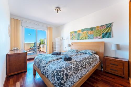 a bedroom with a bed and a view of the ocean at Las Terrazas in La Cala de Mijas