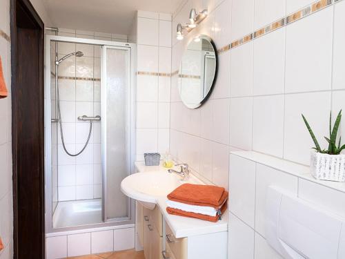 a white bathroom with a sink and a shower at Ferienwohnung Meierhof, 38qm in Sankt Märgen
