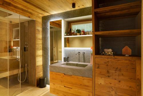 a bathroom with a sink and a mirror at Luxury Chalet Giulia in Torcegno