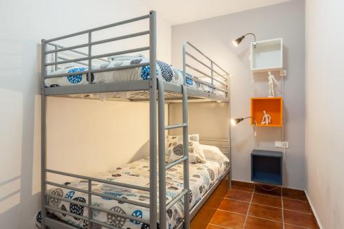 a bedroom with two bunk beds in a room at Masia Alt in Olerdola
