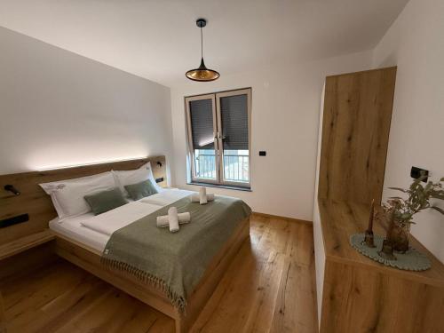 a bedroom with a bed with two candles on it at Apartment Moné - Kope in Slovenj Gradec