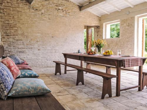 a dining room with a table and a bench at Apartment Cotoneaster by Interhome in Perugia