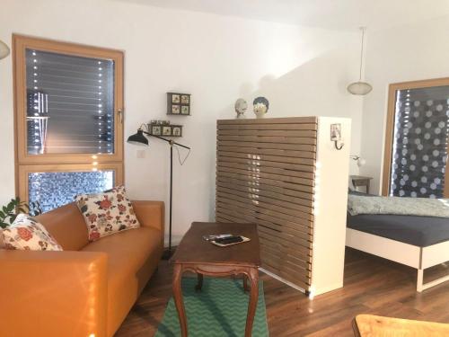 a living room with a couch and a bed at Ferienwohnung Haas Oberschopfheim in Friesenheim
