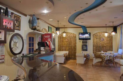 エイスクにあるTornado Hotelの青いパイプが天井に施されたバー付きのレストラン