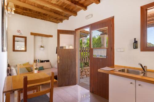 a kitchen and dining room with a table and a sink at Can Mussenya 1 in Illes Balears