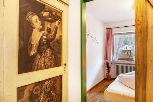 a door to a room with a painting on the wall at Aschaubichl - Wohnung Alpenrose in Grainau