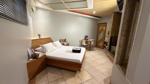 a small room with a bed and a table at KANKUN MOTEL SOROCABA -Adult only in Sorocaba