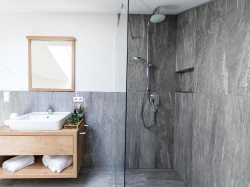 a bathroom with a sink and a shower at Zum Sonnentor App Larix in Lutago