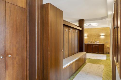 a dressing room with wooden cabinets and a hallway at Bei Kompis in Jenbach