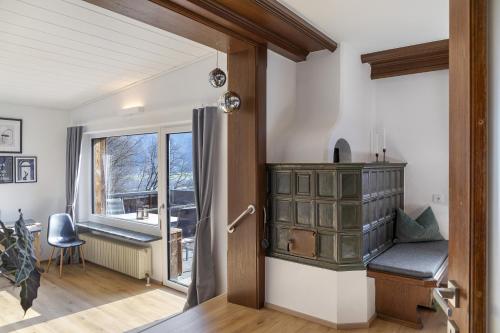 a room with a door with a window and a chair at Bei Kompis in Jenbach