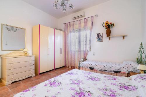 a bedroom with a bed and a dresser and a window at Villetta a Torre Lapillo in Torre Lapillo