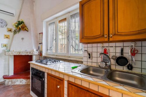 a kitchen with a sink and a stove at Villetta a Torre Lapillo in Torre Lapillo