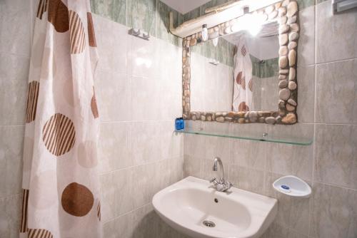 a bathroom with a sink and a mirror at Green Retreats 2 Paros in Isterni
